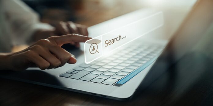 Hand using laptop and press screen to search Browsing on the Internet online.