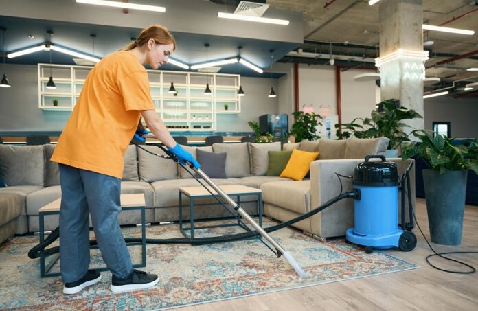 cleaning-company-worker-cleans-a-carpet-in-a-recre-2025-03-08-04-34-52-utc-scaled